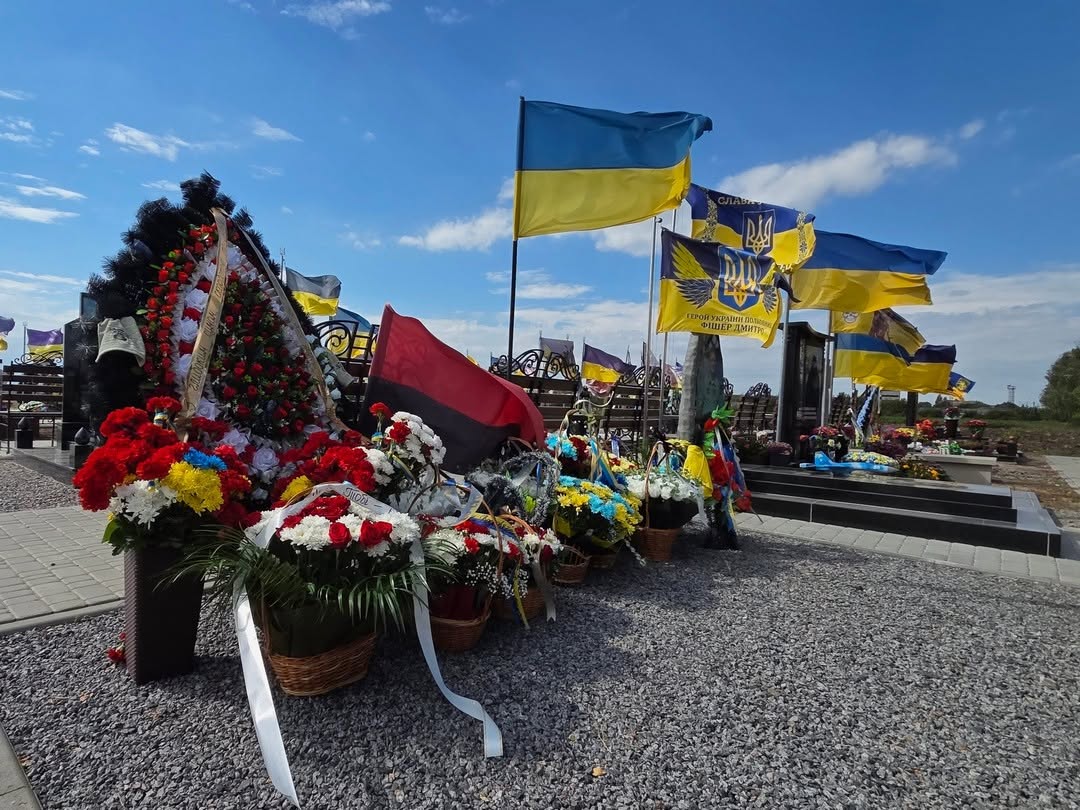 Квіти, вінки та українські прапори біля могил загиблих захисників